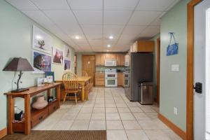 a kitchen with a table and a dining room at Boyne Mountain Getaway, Unit B in Boyne Falls