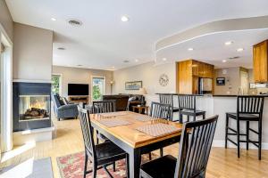 a kitchen and living room with a table and a fireplace at Lake View Getaway in Saugatuck