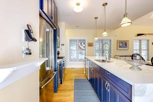 a kitchen with blue and white cabinets and a counter top at The Lighthouse in Lakeshore Cottages in Union Pier