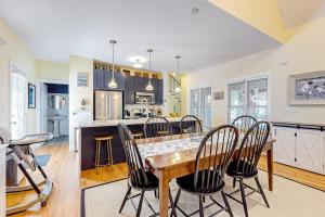 a kitchen and dining room with a table and chairs at The Lighthouse in Lakeshore Cottages in Union Pier