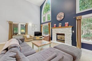 a living room with a couch and a fireplace at The Treehouse in Thompsonville
