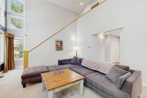 a living room with a couch and a table at The Treehouse in Thompsonville