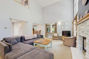 a living room with a couch and a fireplace at The Treehouse in Thompsonville