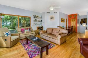 a living room with two couches and a table at Jacobia Lakefront Retreat in Covert