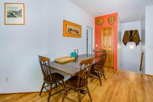 a dining room with a table and four chairs at Jacobia Lakefront Retreat in Covert