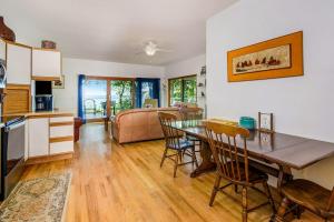 a kitchen and living room with a table and chairs at Jacobia Lakefront Retreat in Covert