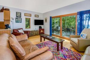 a living room with a couch and a table at Jacobia Lakefront Retreat in Covert