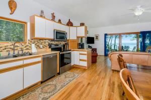 a kitchen with a sink and a stove top oven at Jacobia Lakefront Retreat in Covert +25 photos