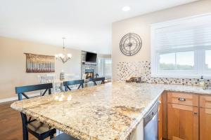 a kitchen with a marble counter top and a dining room at Mountain Top 713 in Thompsonville