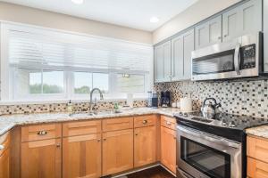 a kitchen with wooden cabinets and a stove top oven at Mountain Top 713 in Thompsonville
