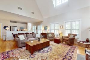 a living room with a couch and a table at Seaglass Lakeshore Cottage in Union Pier