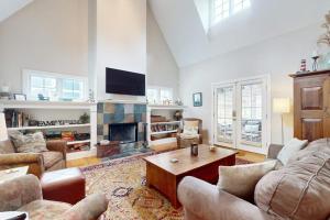 a living room with a couch and a fireplace at Seaglass Lakeshore Cottage in Union Pier