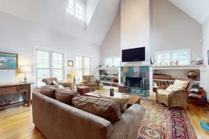 a living room with a couch and a fireplace at Seaglass Lakeshore Cottage in Union Pier