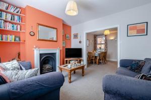 a living room with two blue couches and a fireplace at 2 Bed in Langton Matravers oc-d28351 in Langton Matravers