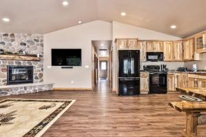 a kitchen with wooden cabinets and a black refrigerator at The Raccoon in Conover
