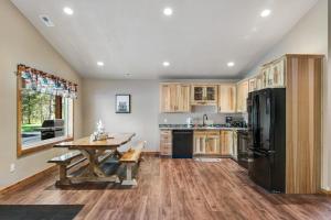 a kitchen with a table and a black refrigerator at The Bear in Conover