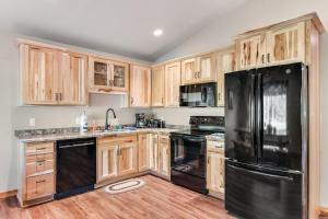 a kitchen with wooden cabinets and a black refrigerator at The Bear in Conover +47 photos