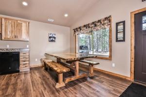 a dining room with a wooden table and benches at The Wildwood in Conover