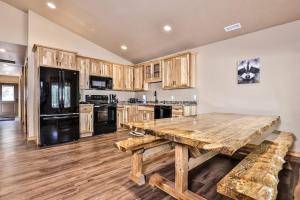 a kitchen with a wooden table and a black refrigerator at The Wildwood in Conover