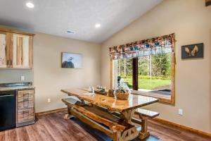 a kitchen with a wooden table and a large window at The Woodland in Conover