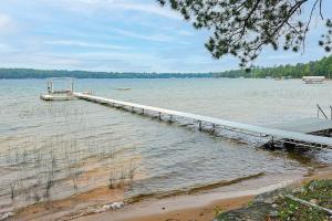 a dock in the middle of a large body of water at Serenity at Stormy Lake in Conover