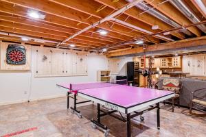 a ping pong table in the middle of a room at Serenity at Stormy Lake in Conover