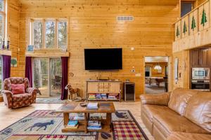 a living room with a couch and a tv at Serenity at Stormy Lake in Conover +55 photos