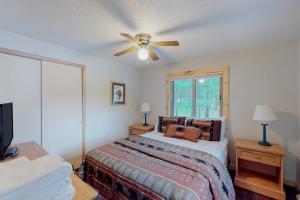 a bedroom with a bed and a ceiling fan at Loon Loft in Saint Germain