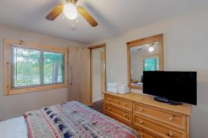a bedroom with a bed and a flat screen tv at Loon Loft in Saint Germain +11 photos
