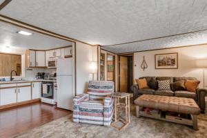 a living room with a couch and a kitchen at The Trail Hub in Mercer