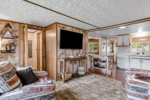 a living room with a couch and a tv at The Trail Hub in Mercer +32 photos