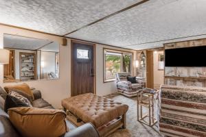 a living room with a couch and a flat screen tv at The Trail Hub in Mercer