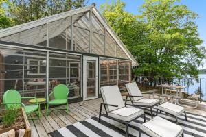 a house with chairs and tables on a deck at Northwoods Oasis in Land O' Lakes