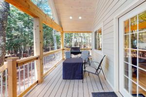 a screened in porch with a table and chairs on it at Chalet on the Bay in Saint Germain