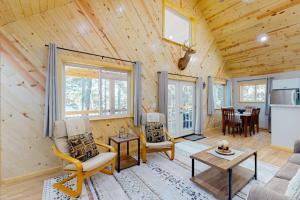 a log cabin with a living room and a kitchen at Chalet on the Bay in Saint Germain