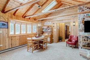 a dining room with a table and chairs at Stormy Point Cabin in Conover