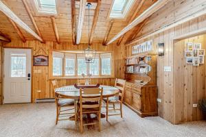 a dining room with a table and chairs at Stormy Point Cabin in Conover +35 photos