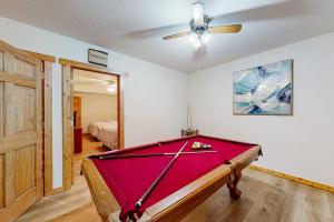 a pool table in a room with a ceiling fan at Moon Ridge Lodge in Saint Germain