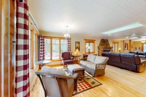 a living room with a couch and a table at Moon Ridge Lodge in Saint Germain
