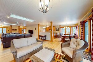 a living room with a couch and chairs and a table at Moon Ridge Lodge in Saint Germain