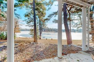 a porch with a view of a lake and trees at Yellow Birch Memories in Eagle River