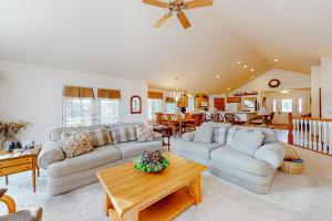 a living room with two couches and a table at Yellow Birch Memories in Eagle River +35 photos