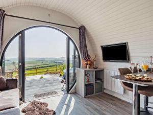 a living room with an open door to a patio at 1 Bed in South Brent oc-86947 in South Brent