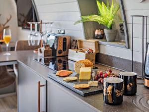 a kitchen counter with bread and cheese on a table at 1 Bed in South Brent oc-86947 in South Brent +6 photos