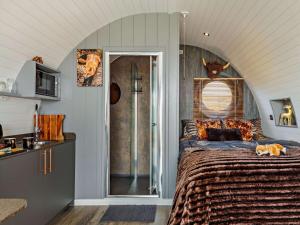 a bedroom with a large bed with an arched ceiling at 1 Bed in South Brent oc-86947 in South Brent