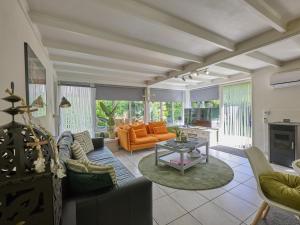 a living room with a couch and a table at Bungalow Sonnerust in Lanaken
