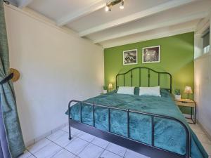 a bedroom with a bed and a green wall at Bungalow Sonnerust in Lanaken