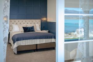 a bedroom with a bed with a view of the ocean at The Pier Hotel in Kaikoura