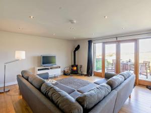 a living room with a large couch and a television at 2 Bed in Holmfirth oc-emley in New Mills