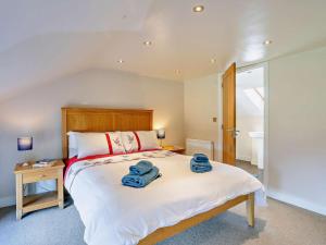 a bedroom with a large bed with towels on it at 2 Bed in Holmfirth oc-emley in New Mills +14 photos